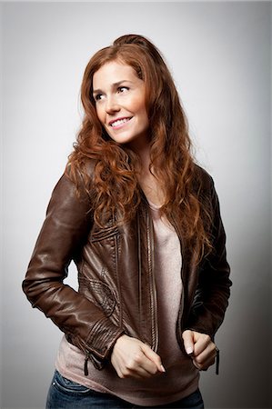 fiore dello zenzero - Smiling woman wearing jacket Fotografie stock - Premium Royalty-Free, Codice: 614-06537455