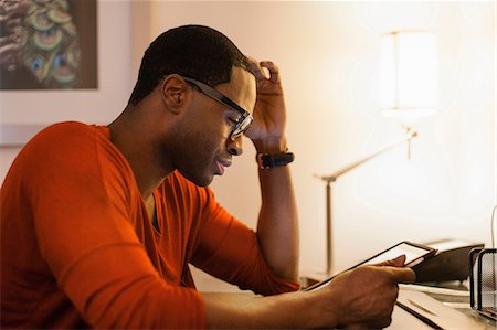 eyeglasses detail - Man using tablet computer at desk Stock Photo - Premium Royalty-Free, Code: 614-06537451