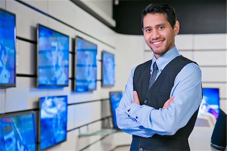 enjoying television - Salesman smiling in store Stock Photo - Premium Royalty-Free, Code: 614-06537461