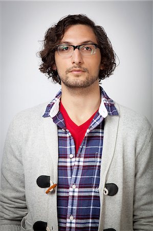 portrait young man white background - Man wearing glasses indoors Stock Photo - Premium Royalty-Free, Code: 614-06537498