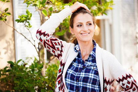 sun watch - Smiling woman standing outdoors Stock Photo - Premium Royalty-Free, Code: 614-06537507