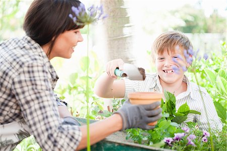 planting - Mother and son potting plants outdoors Stock Photo - Premium Royalty-Free, Code: 614-06624059