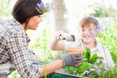 Mother and son potting plants outdoors Stock Photo - Premium Royalty-Free, Code: 614-06624059