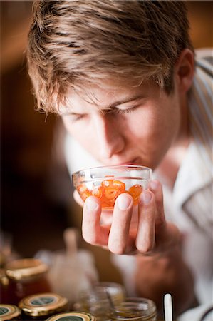 fragrance - Man smelling preserves in grocery Stock Photo - Premium Royalty-Free, Code: 614-06624090