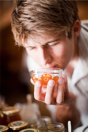 smell - Man smelling preserves in grocery Stock Photo - Premium Royalty-Free, Code: 614-06624090