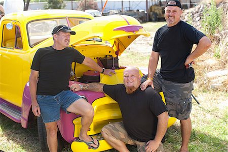 Men smiling with colorful car Stock Photo - Premium Royalty-Free, Code: 614-06624115