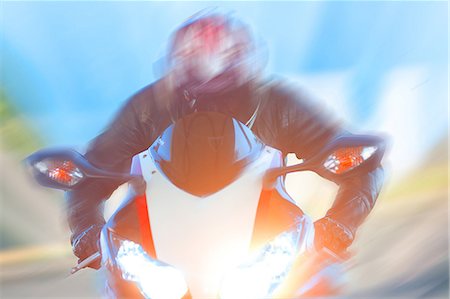 speed travel - Blurred view of man riding motorcycle Stock Photo - Premium Royalty-Free, Code: 614-06624129
