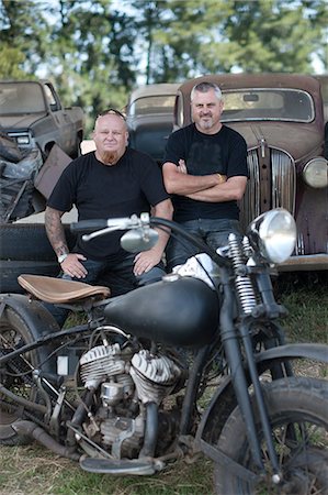 rusting car - Men sitting with motorcycle Stock Photo - Premium Royalty-Free, Code: 614-06624131