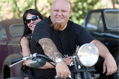 portrait tattoos of women - Couple sitting on motorcycle Stock Photo - Premium Royalty-Free, Code: 614-06624140