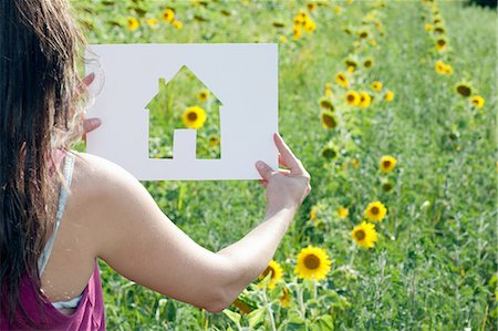 dreaming - Woman holding card with house shape Stock Photo - Premium Royalty-Free, Code: 614-06624161