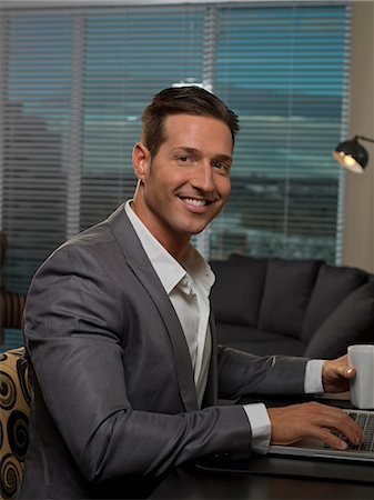 Businessman smiling at desk Stock Photo - Premium Royalty-Free, Code: 614-06624198