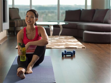 simsearch:614-06718872,k - Woman resting on yoga mat in living room Photographie de stock - Premium Libres de Droits, Code: 614-06624262