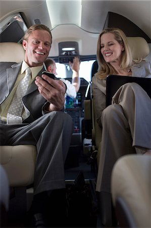 Business people talking in airplane Stock Photo - Premium Royalty-Free, Code: 614-06624349