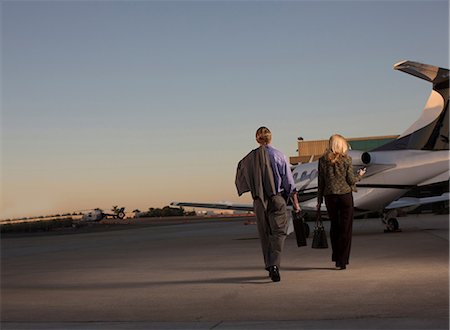 private plane business man - Business people on airplane runway Stock Photo - Premium Royalty-Free, Code: 614-06624362