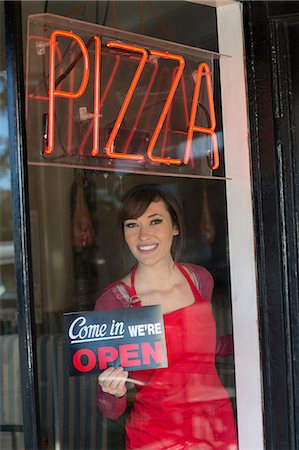 food processing aprons - Woman putting open sign in window Stock Photo - Premium Royalty-Free, Code: 614-06624466