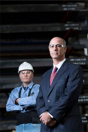 safety glasses - Businessman and worker in metal plant Stock Photo - Premium Royalty-Free, Code: 614-06624486
