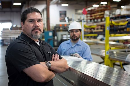 steel factory worker - Worker standing in metal plant Stock Photo - Premium Royalty-Free, Code: 614-06624516