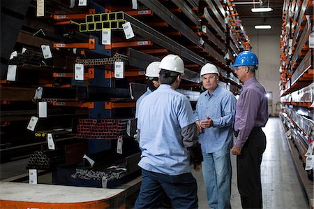 Workers and businessman in metal plant Stock Photo - Premium Royalty-Free, Code: 614-06624554