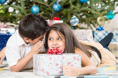 simsearch:614-06624568,k - Children whispering by Christmas tree Stock Photo - Premium Royalty-Free, Code: 614-06624569