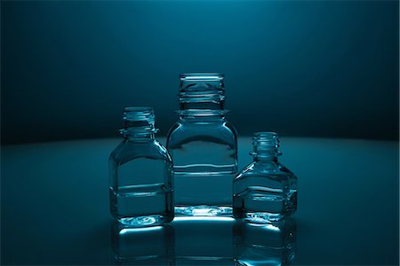 Glass bottles of clear liquid Stock Photo - Premium Royalty-Free, Code: 614-06624605