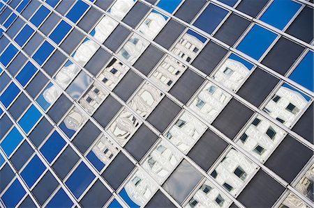 reflective backgrounds - Urban skyscraper reflected in windows Stock Photo - Premium Royalty-Free, Code: 614-06624714