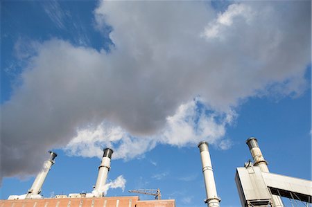 simsearch:649-08561987,k - Factory smokestacks against blue sky Stock Photo - Premium Royalty-Free, Code: 614-06624722