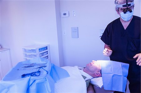 surgery tray - Surgeon with patient in operating room Stock Photo - Premium Royalty-Free, Code: 614-06624795