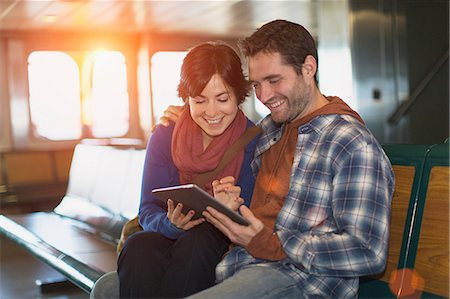 Couple using tablet computer on ferry Stock Photo - Premium Royalty-Free, Code: 614-06624999