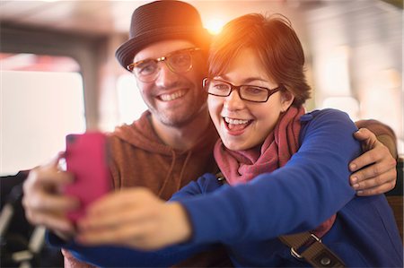 female holding a mobile phone - Couple taking picture with cell phone Stock Photo - Premium Royalty-Free, Code: 614-06625004