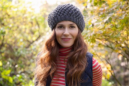 Smiling woman standing outdoors Stock Photo - Premium Royalty-Free, Code: 614-06625034