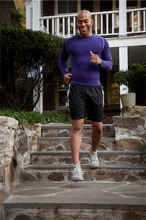 porch person - Man jogging on steps outdoors Stock Photo - Premium Royalty-Free, Code: 614-06625035