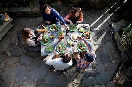 drinking wine people party - Friends eating together outdoors Stock Photo - Premium Royalty-Free, Code: 614-06625095