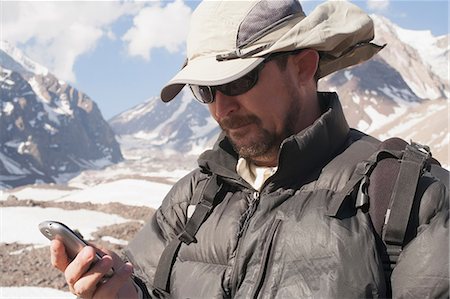 santiago province - Hiker with cell phone in snowy mountains Photographie de stock - Premium Libres de Droits, Code: 614-06625119