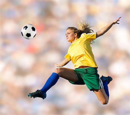 simsearch:614-06625331,k - Soccer player kicking in mid-air Foto de stock - Sin royalties Premium, Código: 614-06625330