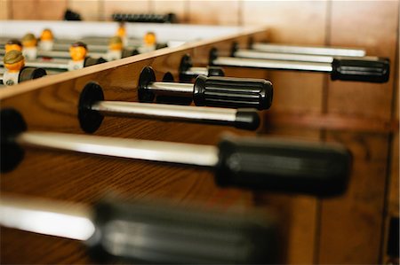 Close up of handles on foosball table Stock Photo - Premium Royalty-Free, Code: 614-06625365