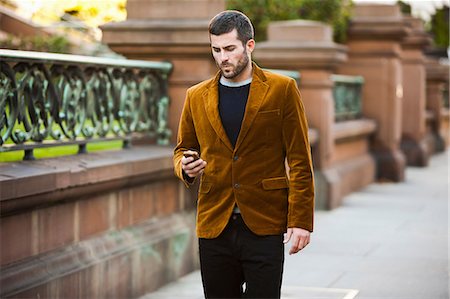 people walking and city - Man using cell phone on city street Stock Photo - Premium Royalty-Free, Code: 614-06625394