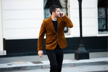 people walking in street - Man talking on cell phone on city street Stock Photo - Premium Royalty-Free, Code: 614-06625395