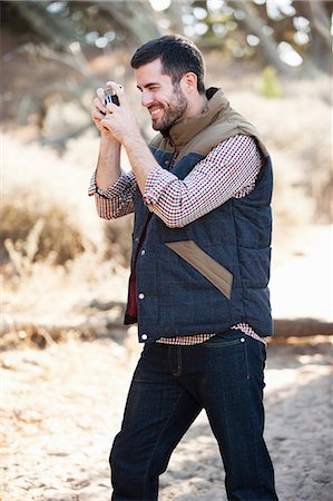 Man taking picture outdoors Stock Photo - Premium Royalty-Free, Code: 614-06625391