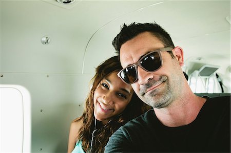 simsearch:614-06624984,k - Smiling couple sitting in airplane Stock Photo - Premium Royalty-Free, Code: 614-06625463