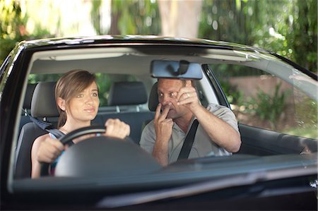 dad teenager - Father teaching teenage daughter driving Stock Photo - Premium Royalty-Free, Code: 614-06623420