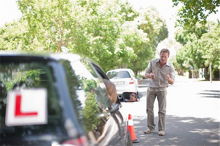 parent teaching outdoor - Father teaching teenage daughter driving Stock Photo - Premium Royalty-Free, Code: 614-06623422