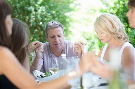 female with eyes closed - Family saying grace before eating Stock Photo - Premium Royalty-Free, Code: 614-06623604