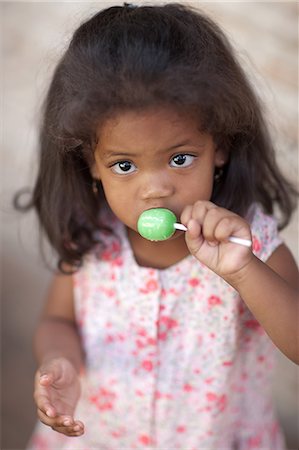 shy people - Girl licking lollipop Stock Photo - Premium Royalty-Free, Code: 614-06623688