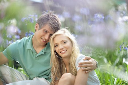Smiling couple sitting in tall plants Stock Photo - Premium Royalty-Free, Code: 614-06623728