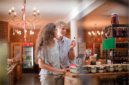 Couple tasting olives in grocery Stock Photo - Premium Royalty-Free, Code: 614-06623825