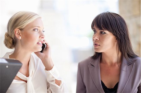 phone worried person - Businesswomen standing outdoors Stock Photo - Premium Royalty-Free, Code: 614-06623836