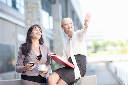 Businesswomen talking on balcony Stock Photo - Premium Royalty-Free, Code: 614-06623860