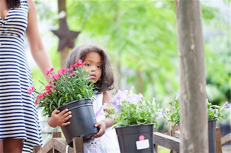 plant nursery - Girl carrying planter outdoors Stock Photo - Premium Royalty-Free, Code: 614-06623923