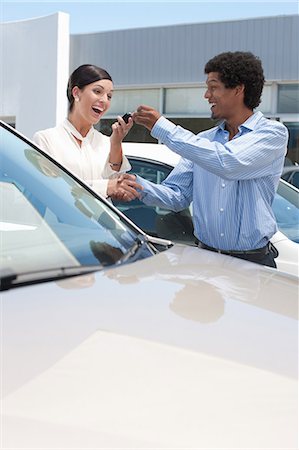 selling car - Woman buying new car from salesman Stock Photo - Premium Royalty-Free, Code: 614-06623950