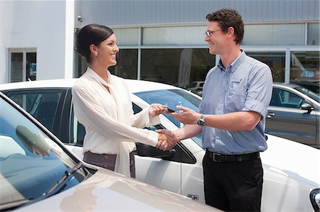 Woman buying new car from salesman Stock Photo - Premium Royalty-Free, Code: 614-06623951